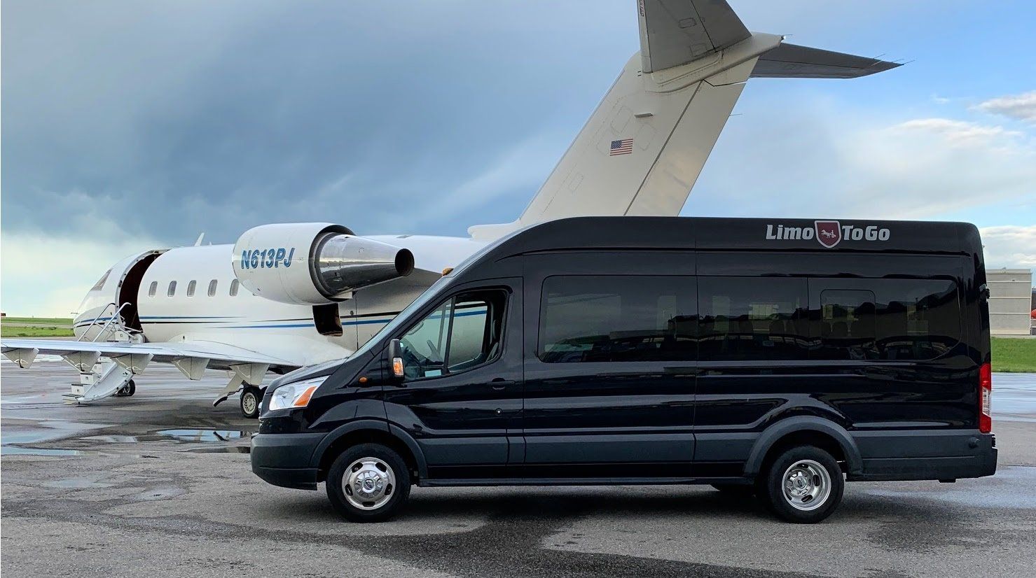 Limo To Go limousine parked beside private jet with Limo To Go logo