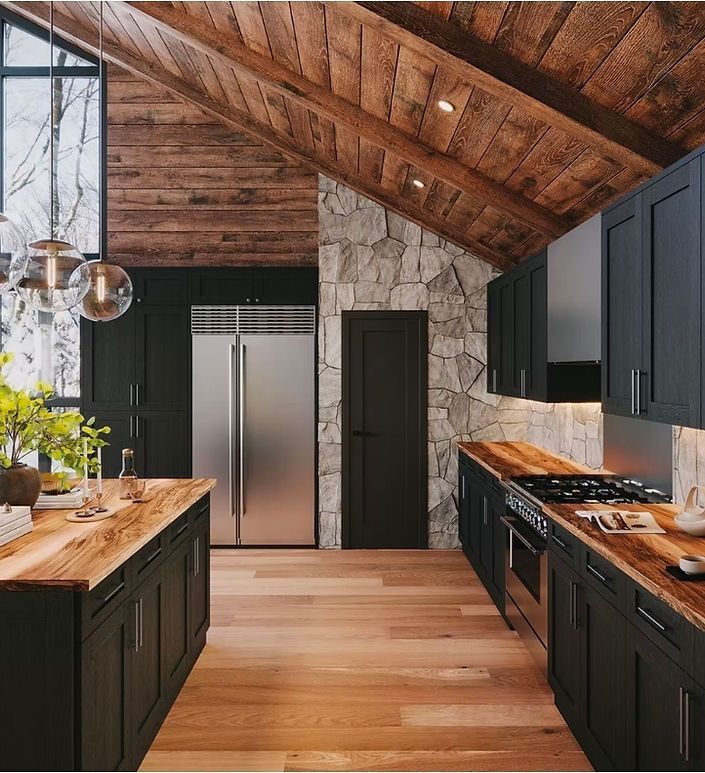 Rustic modern kitchen with dark cabinets, wood ceiling, stainless fridge, and island under skylights