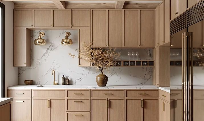 Modern kitchen with beige cabinets, marble backsplash, brass lights, and a vase of dried branches.