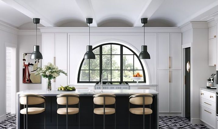 Bright modern kitchen with arched window, black island, and beige stools