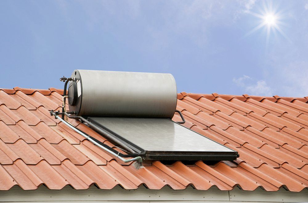 A Solar Water Heater is Mounted on the Roof of a House — SOS Hot Water & Plumbing Services in Kiama Downs, NSW