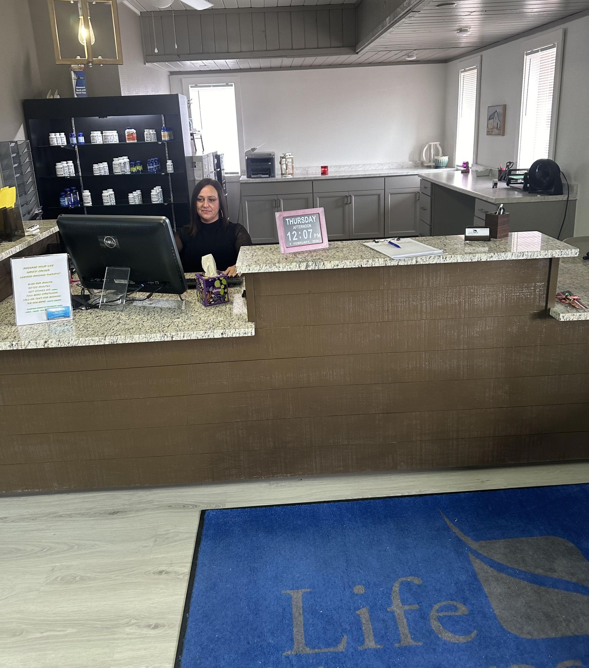 A woman is sitting at a counter in a life insurance office