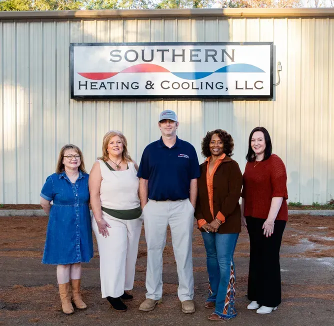 Four people stand outside a building with 
