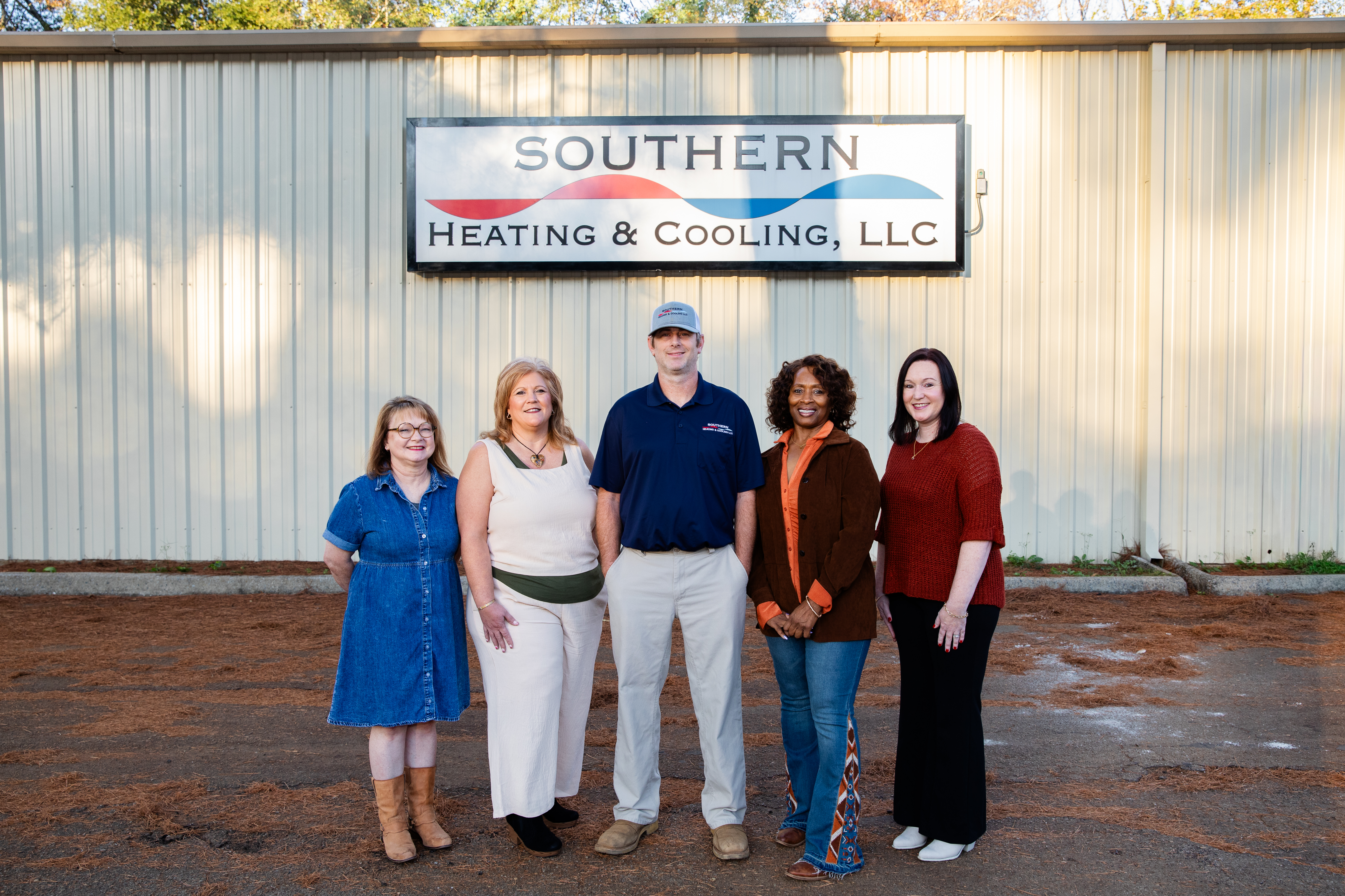 Four people stand outside a building with 