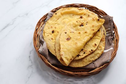 Fresh handmade roti on a wooden board