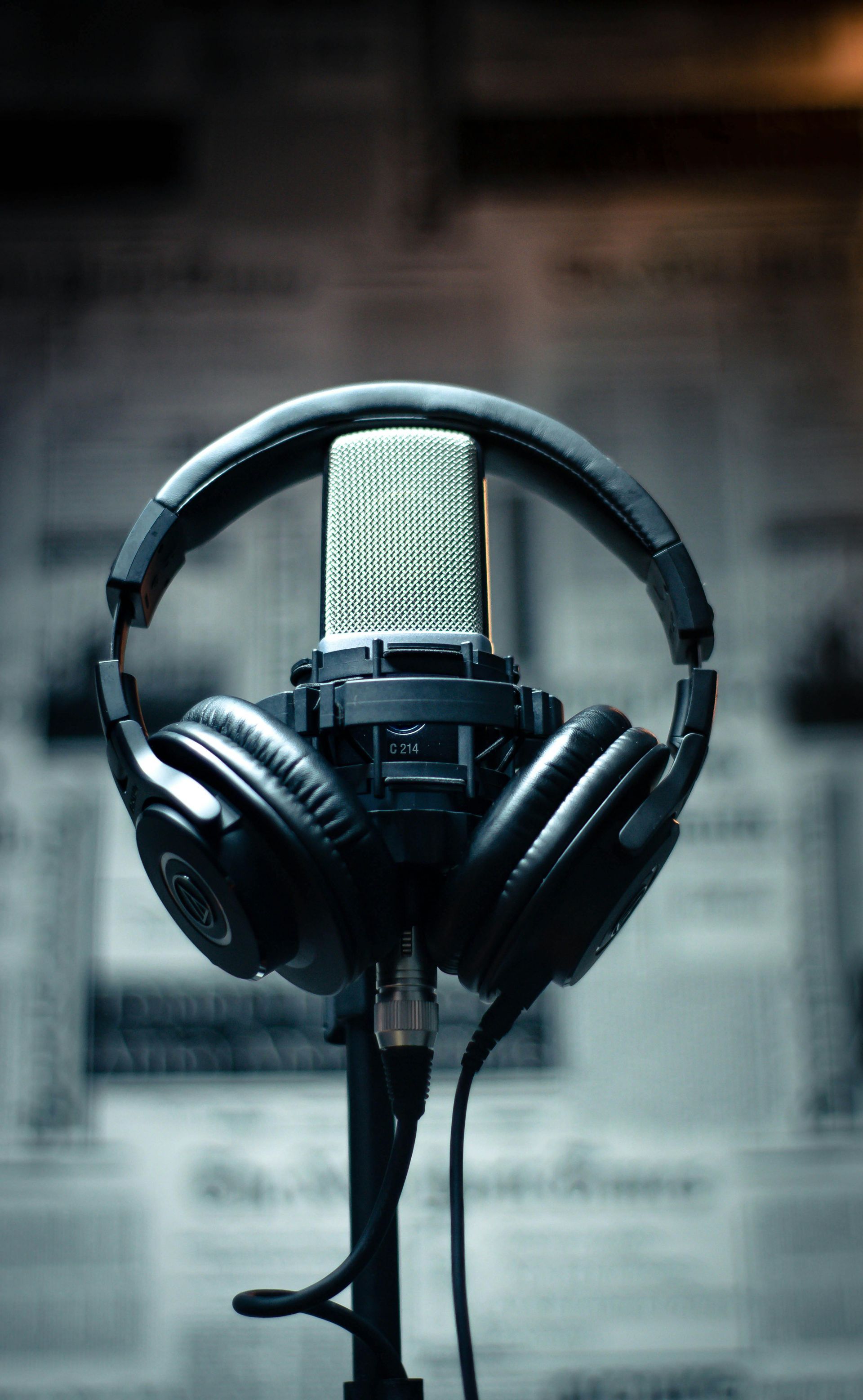 Black headphones on a microphone stand in a studio setting