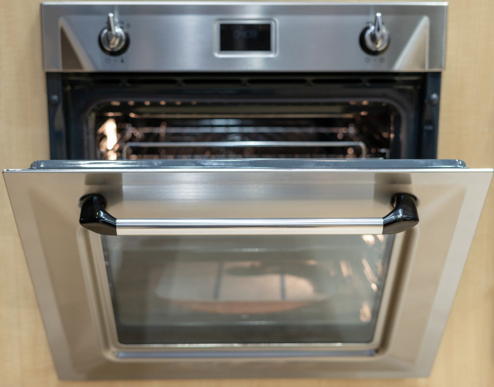 A stainless steel oven with the door open.