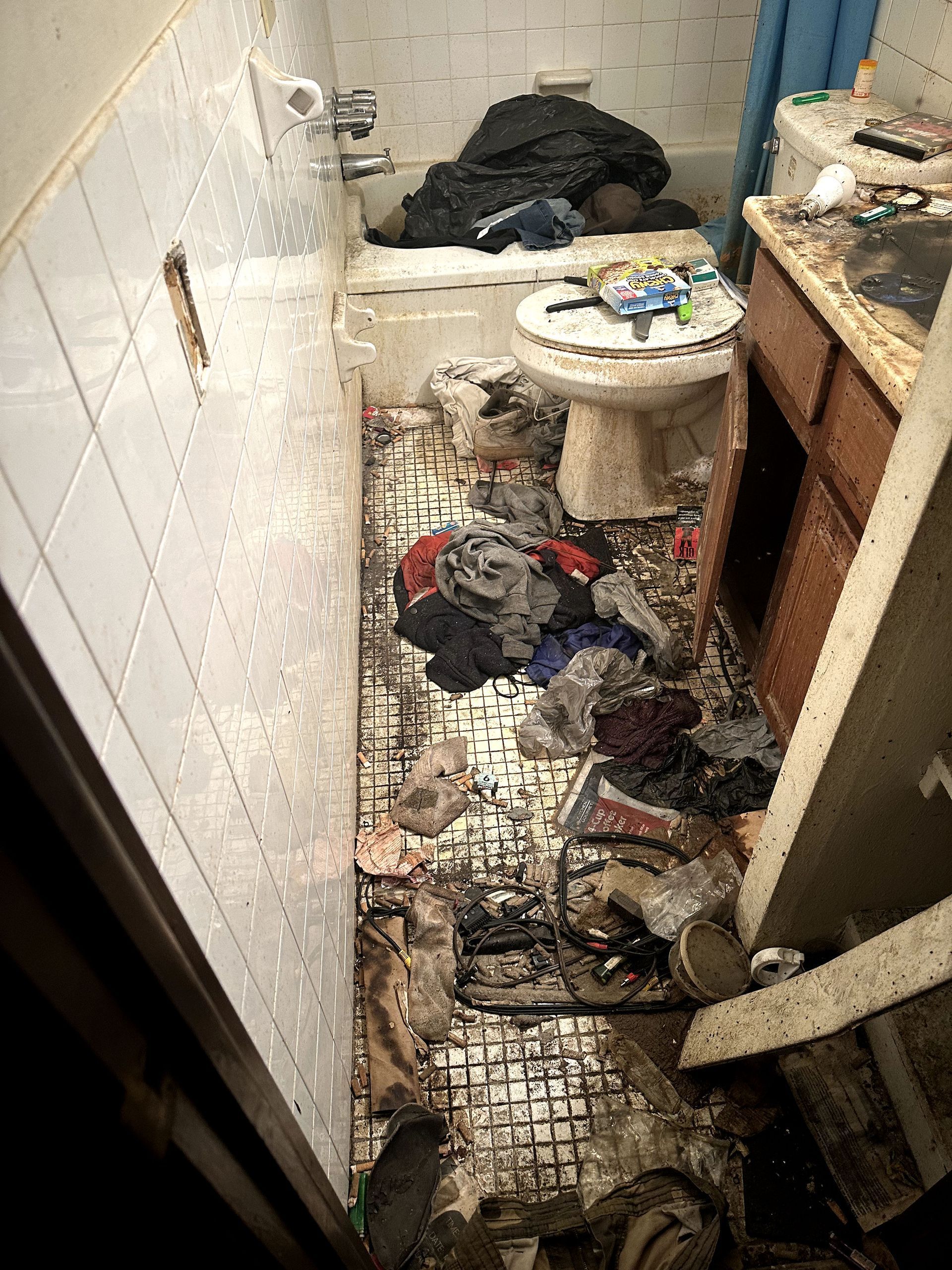 A before shot of a bathroom in a hoard cleanup in Pittsburgh, PA by Kingdom Bio Recovery & Restoration