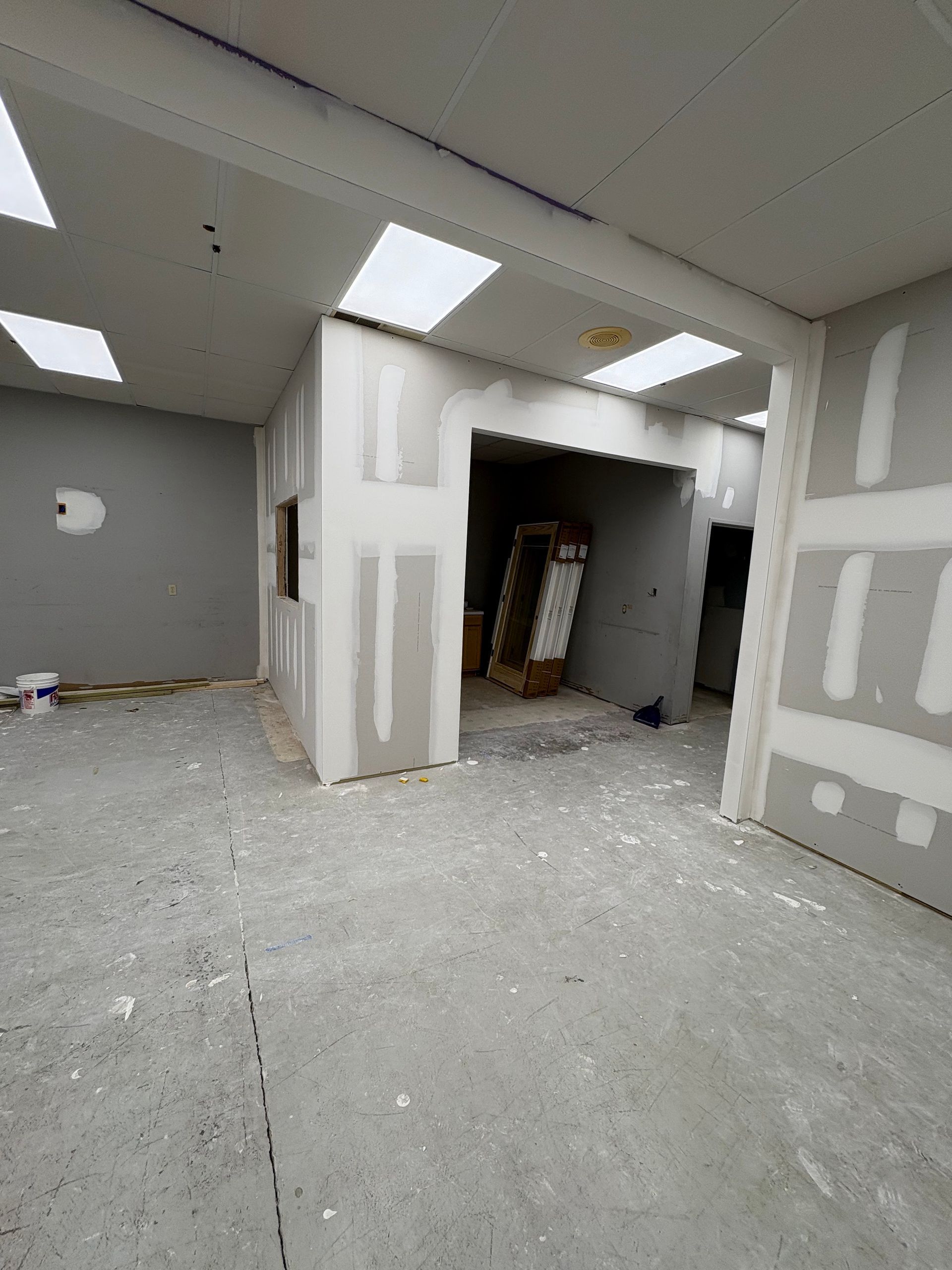 An empty room with drywall on the walls and ceiling.