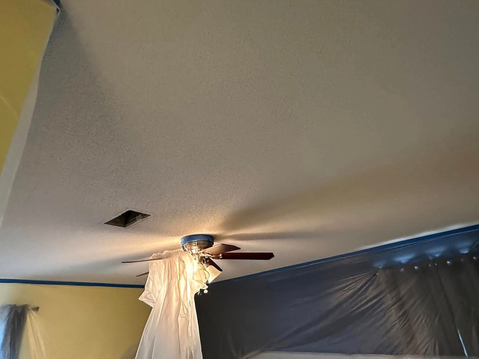 A ceiling fan is hanging from the ceiling of a room.