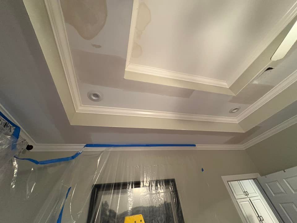 A room with a ceiling that is covered in plastic and a picture on the wall.