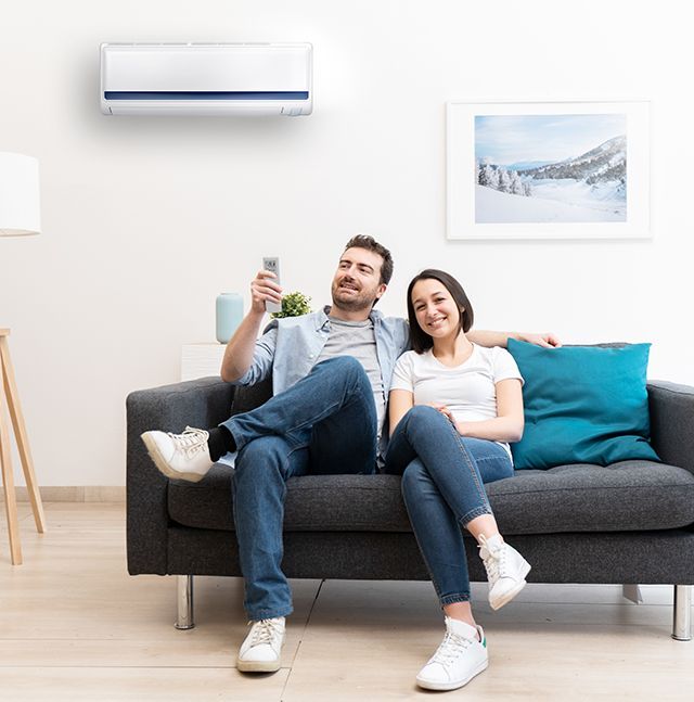Couple Sitting on Couch — Summerville, SC — Carolina Air Care