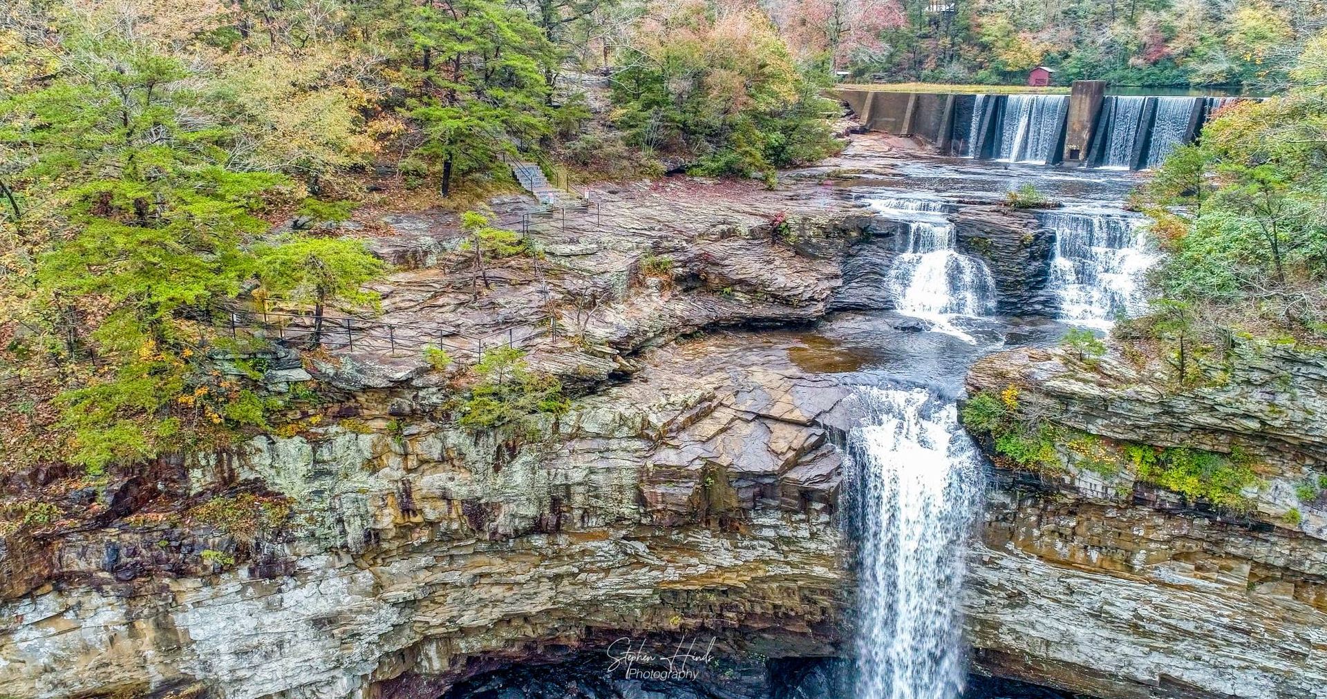 An aerial view of a waterfall in the woods