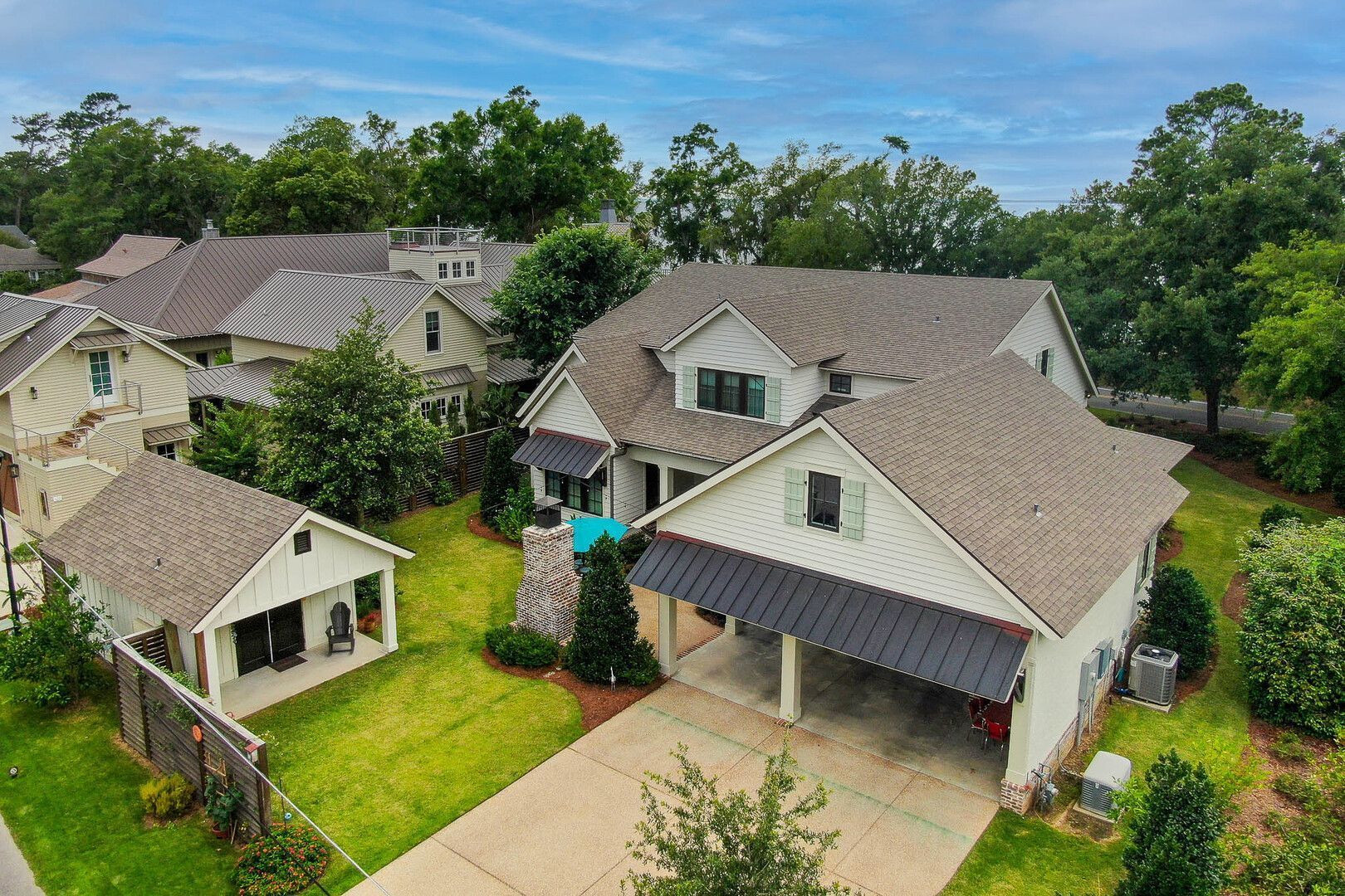An aerial view of a house with a large driveway