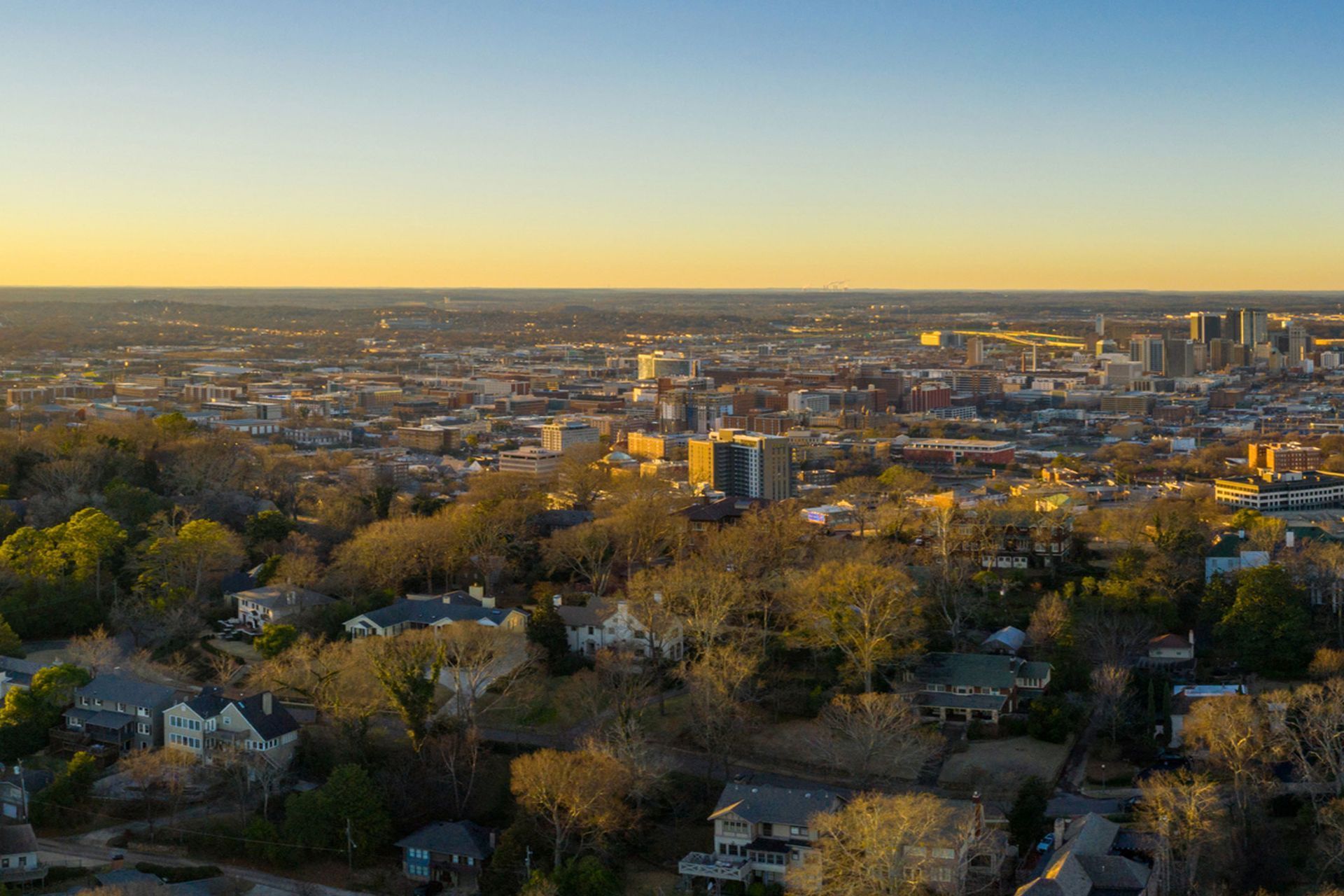 An aerial view of a city with lots of buildings and trees