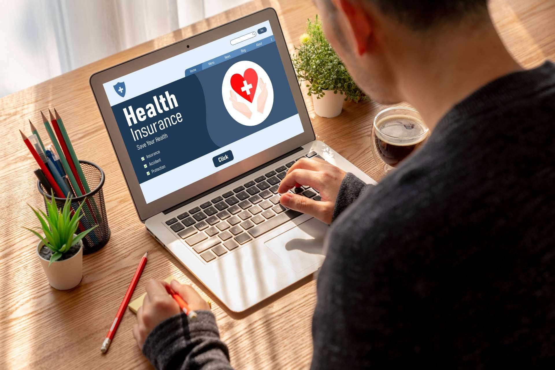Person using a laptop with a health website open at a wooden desk