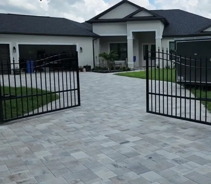 A white house with a black gate in front of it