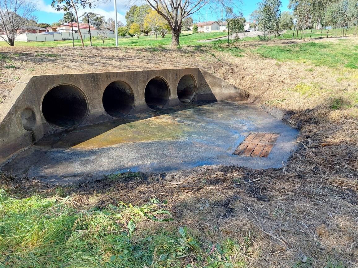 Recently cleaned industrial drains in a council park.