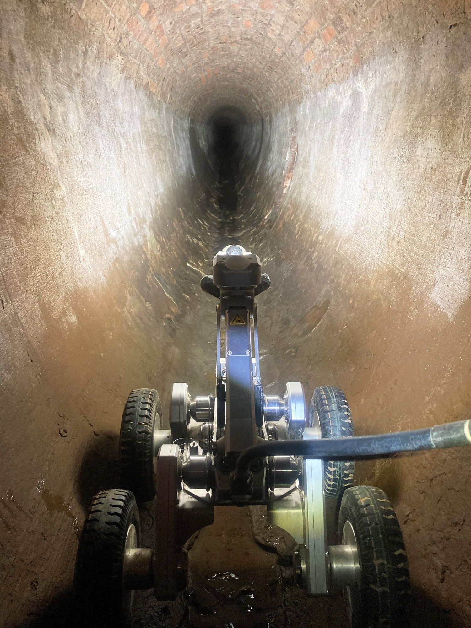 A robot with a camera inspecting a pipeline.
