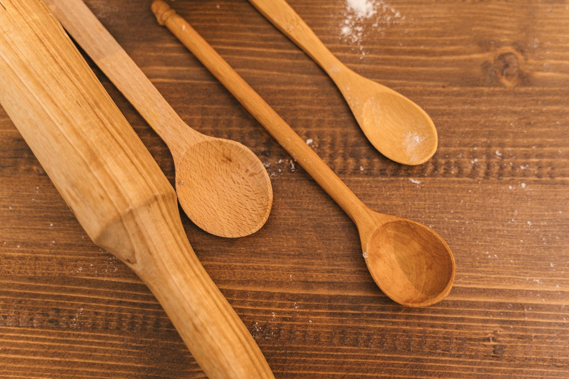 Wooden spoons and utensils on a rustic brown wood table