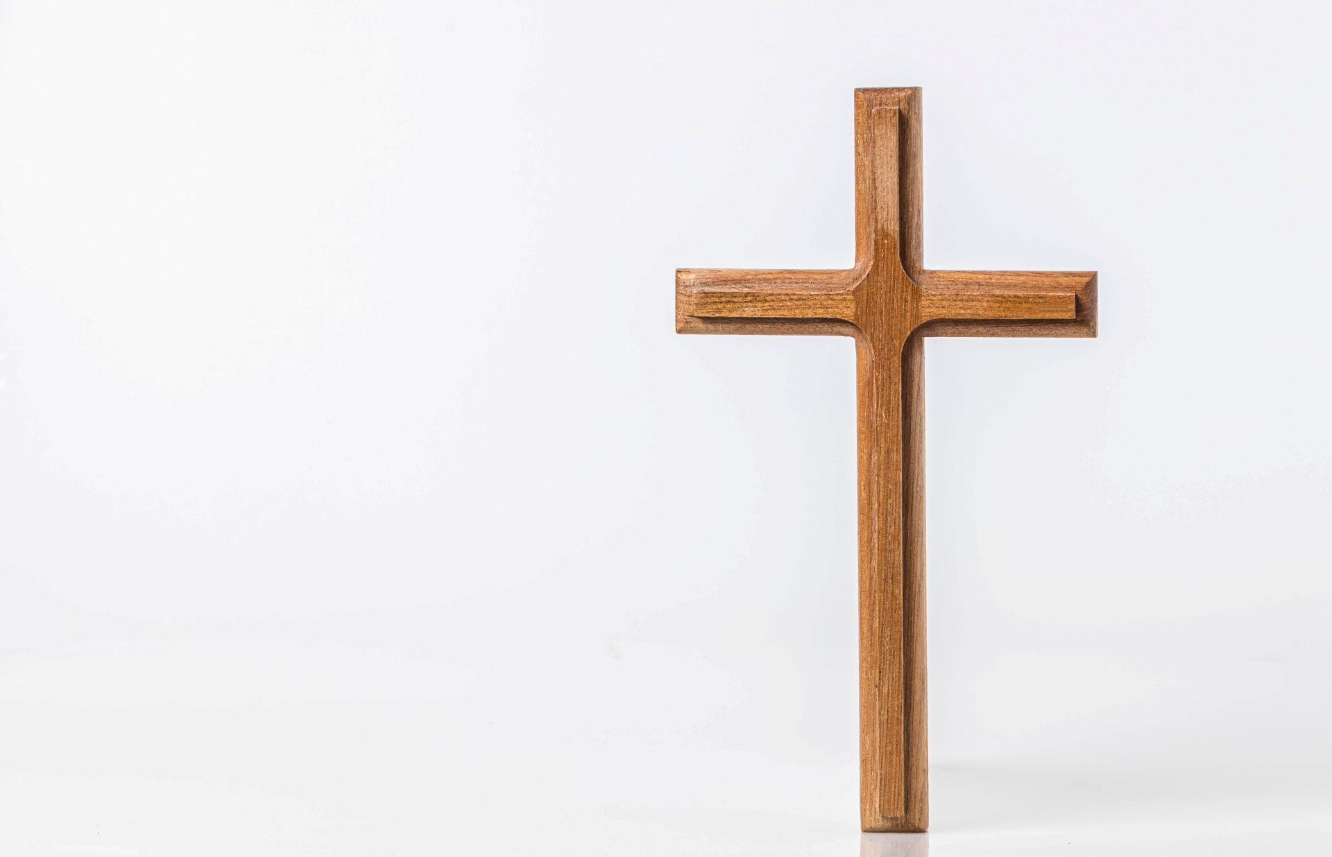 Wooden cross standing on a white background