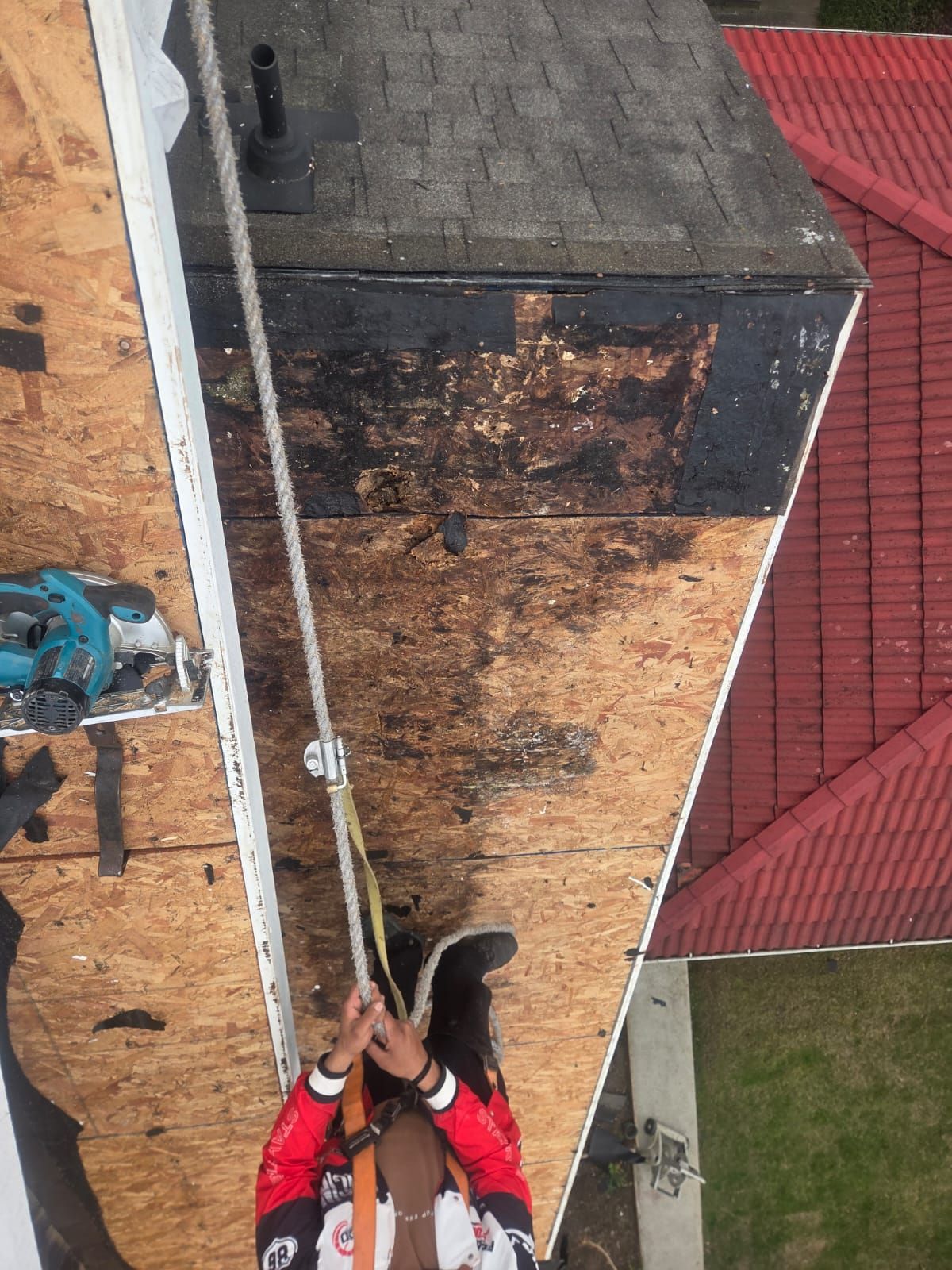Tear off in progress showing moisture damaged deck around plumbing vent stack, Vancouver roof replacement, Paragon Roofing BC