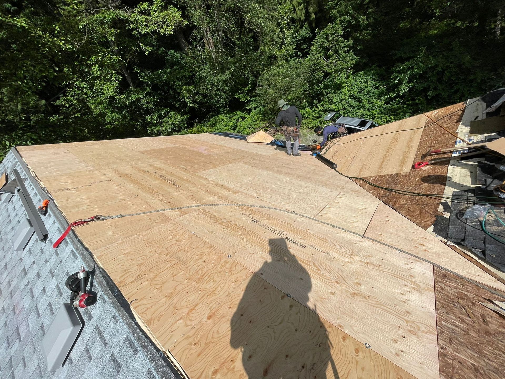 A man is working on the roof of a house.