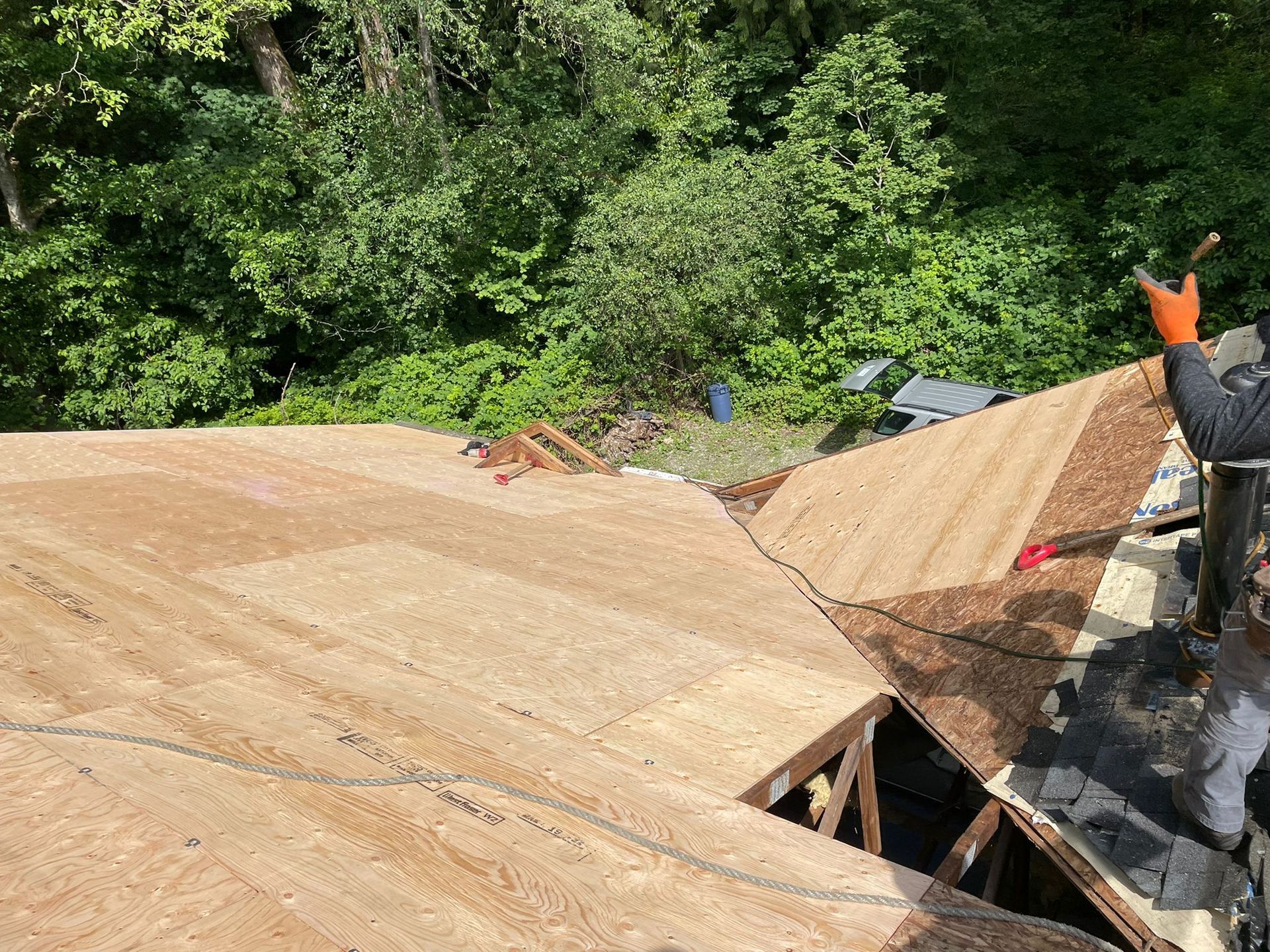 A man is working on the roof of a house.
