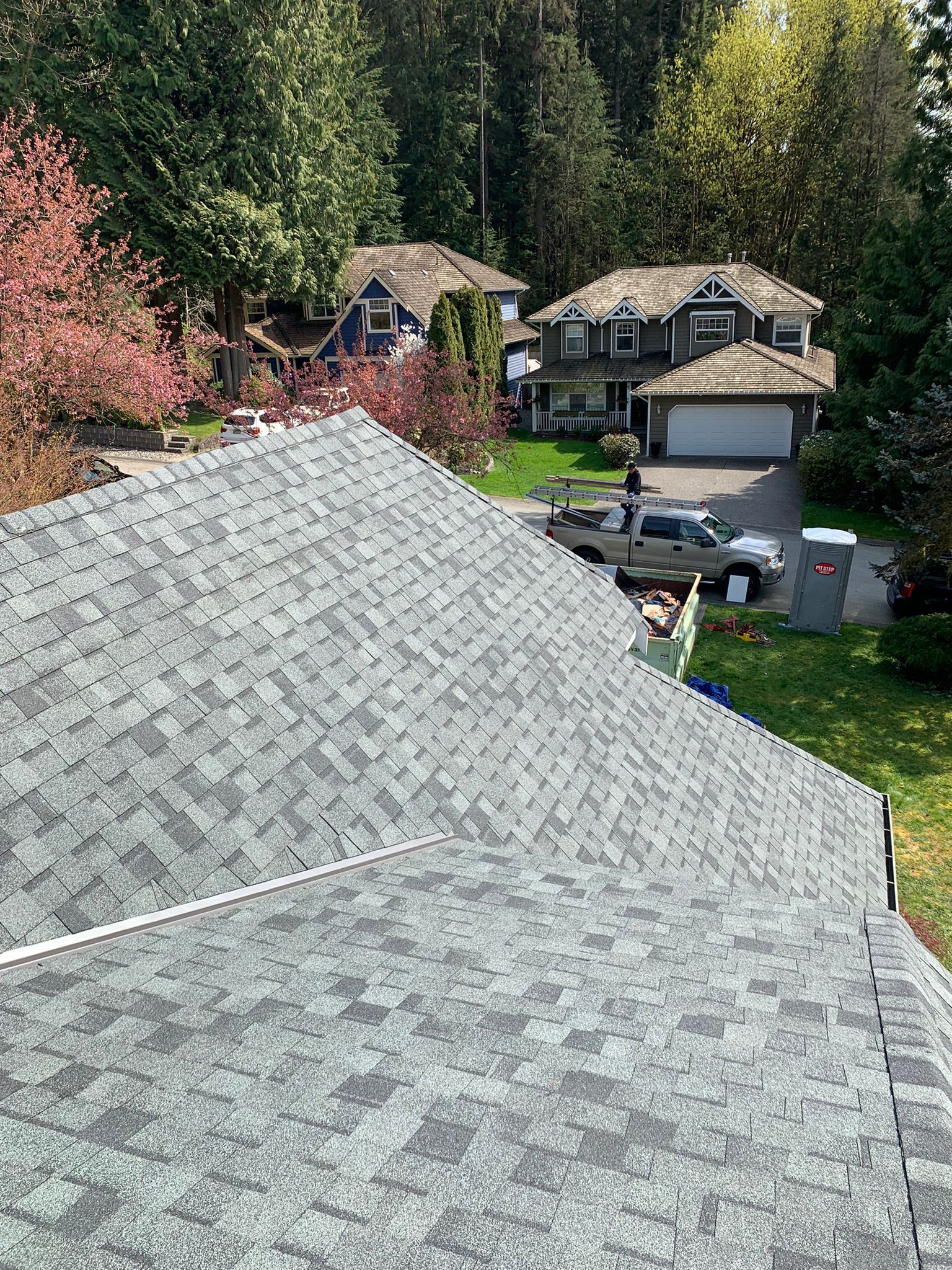 An aerial view of a roof of a house in a residential area.