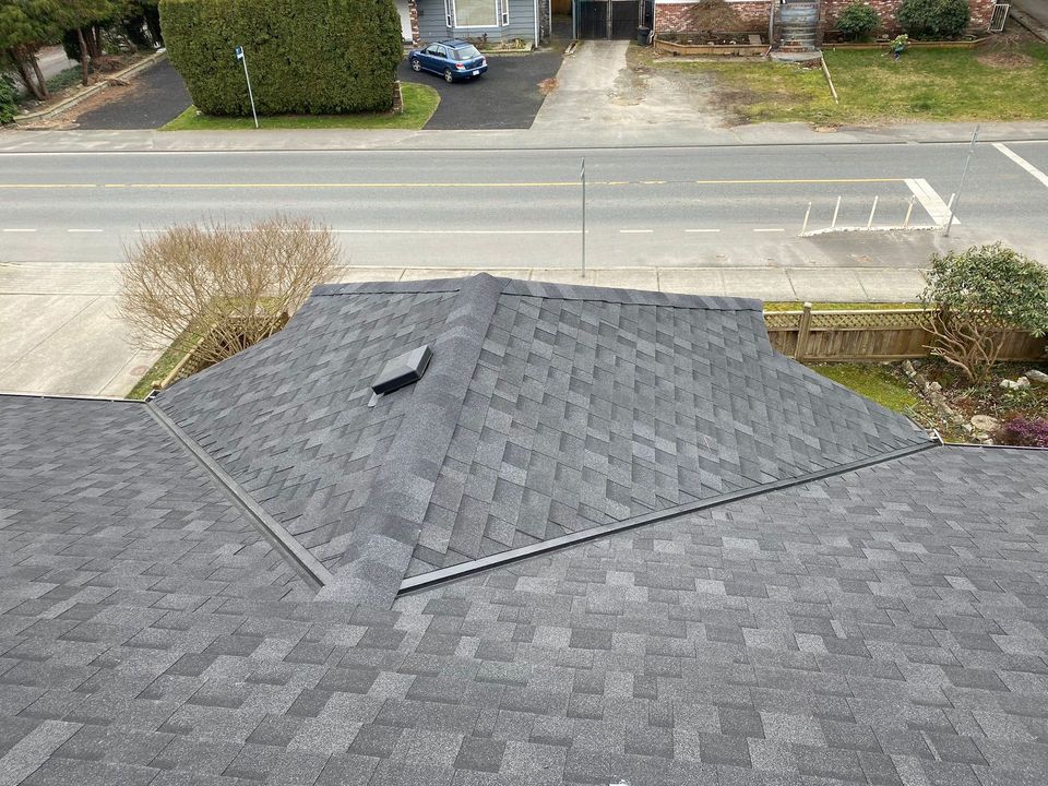 Intersecting asphalt shingle roof planes with valleys and a vent