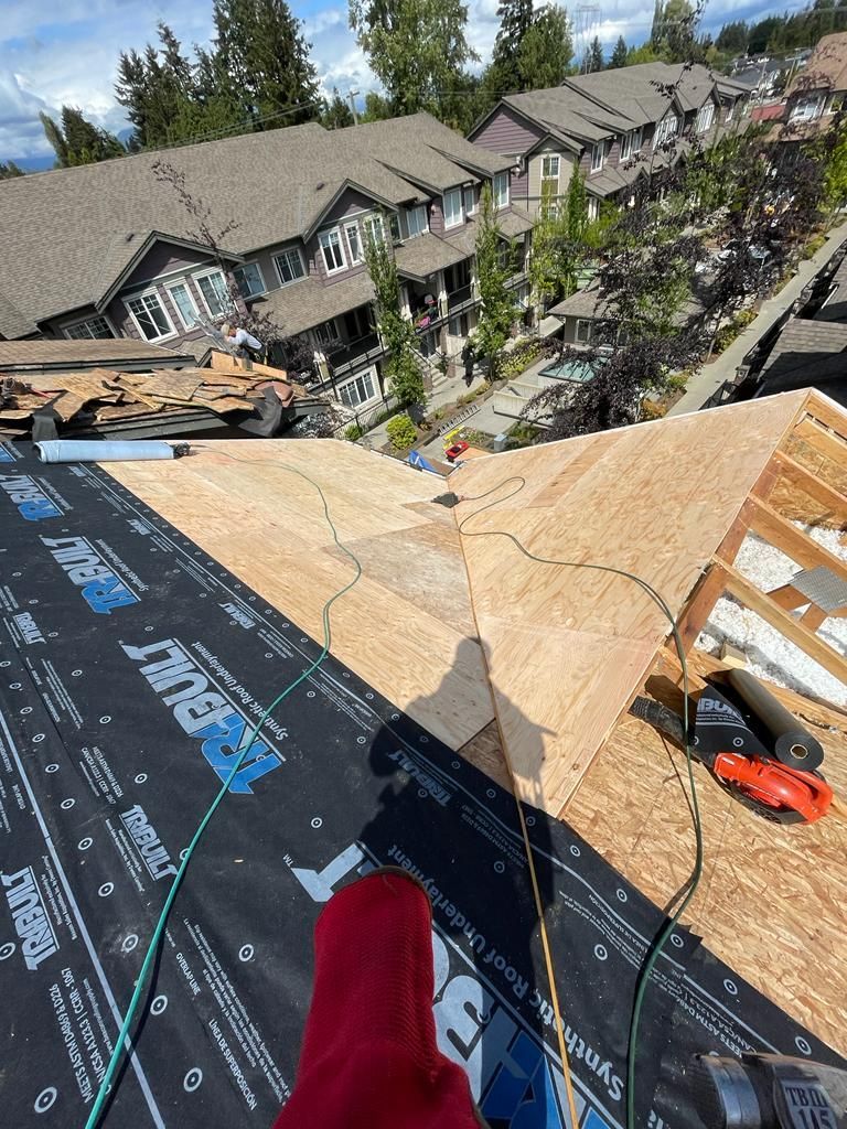 A person is standing on the roof of a building.