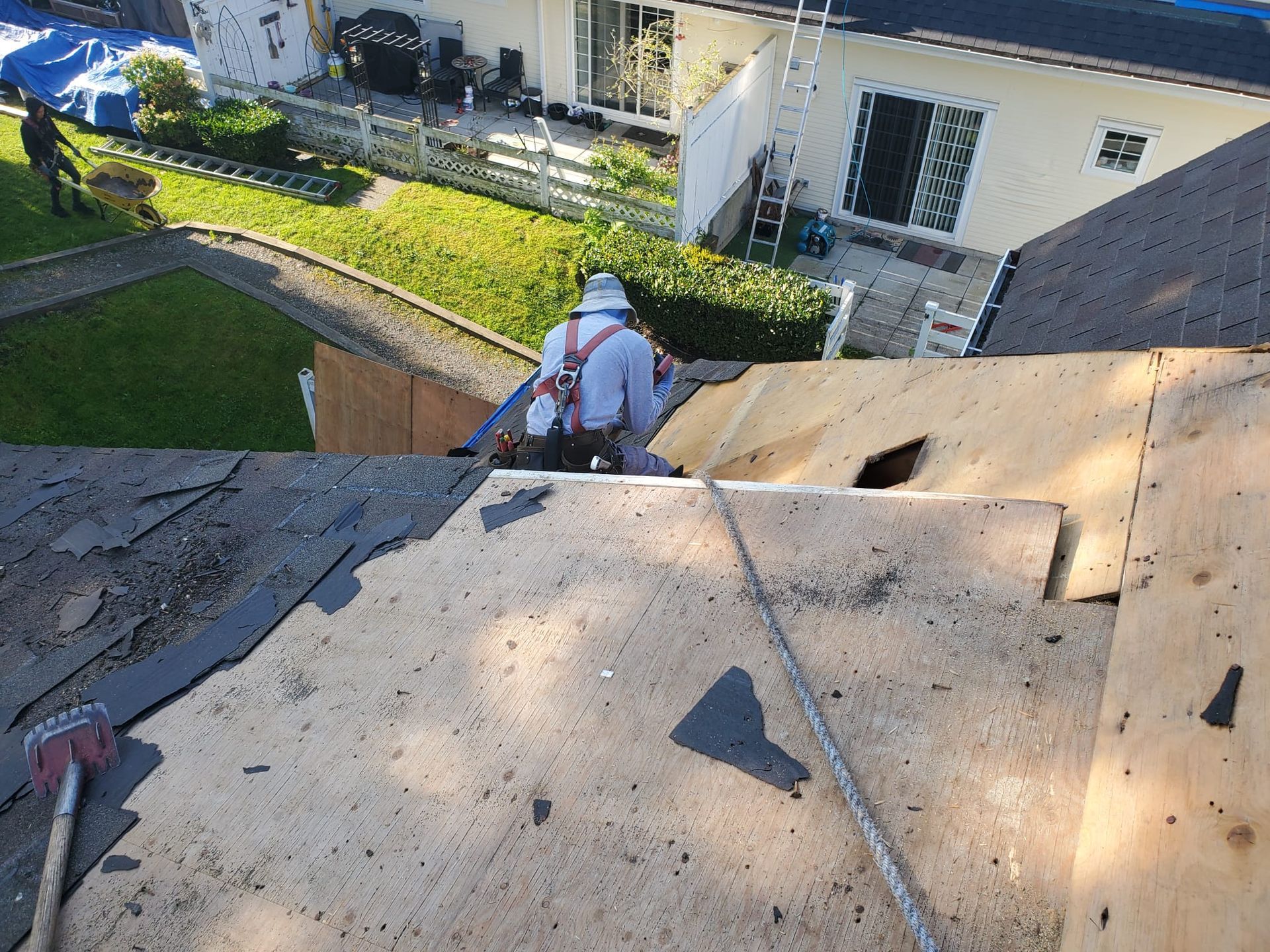 A man is working on the roof of a house.