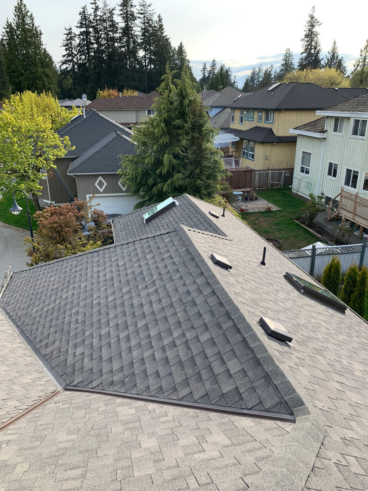 An aerial view of a roof of a house in a residential area.