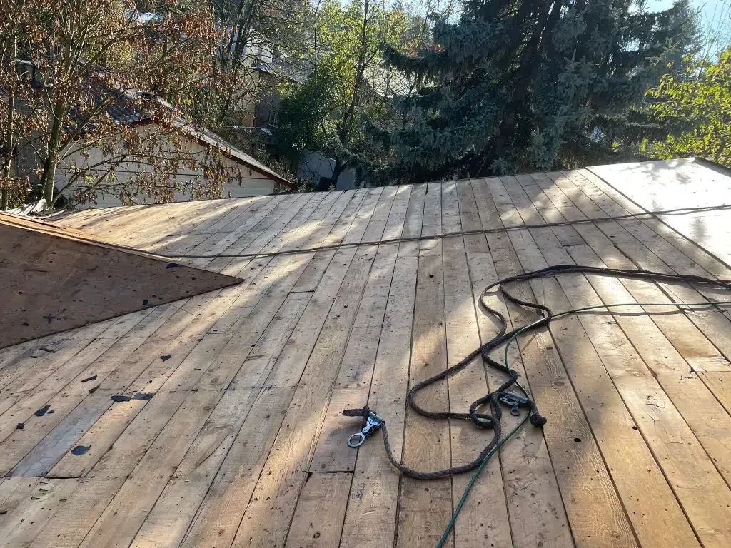 A wooden deck with a cord laying on it.