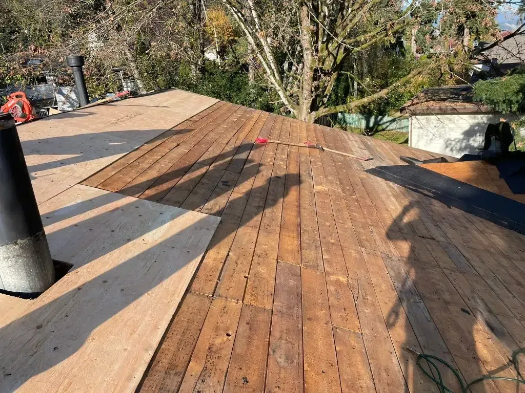 A wooden deck is being built on top of a wooden roof.