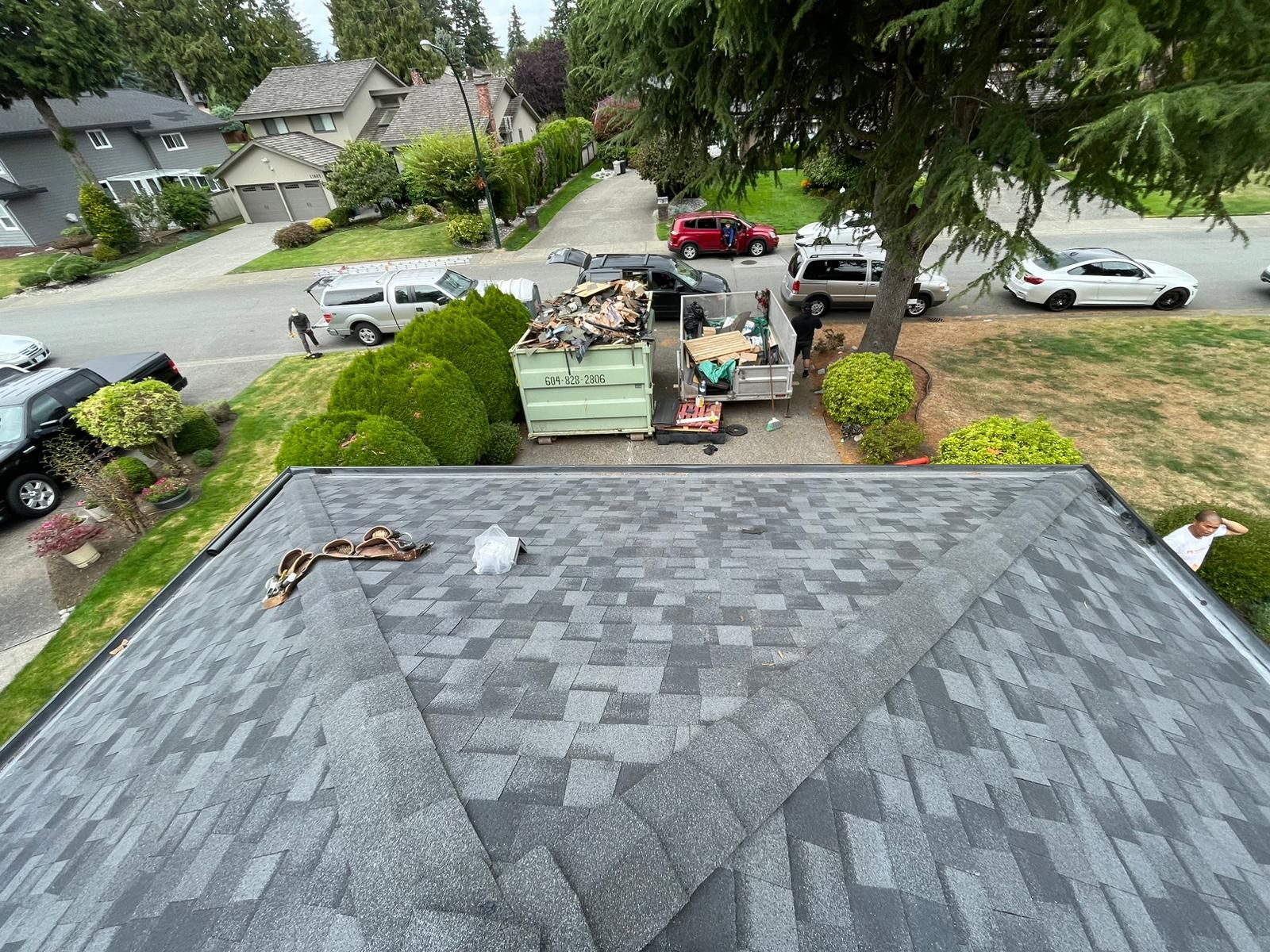 An aerial view of a roof with a dumpster on it.