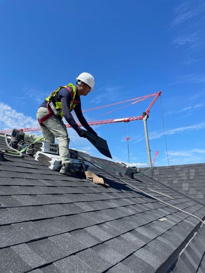 A man is working on the roof of a building.
