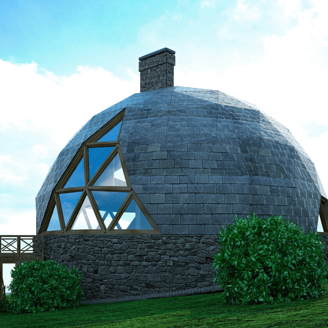 A stone-clad geodesic dome house with large triangular windows, a chimney, and a wooden porch set against a blue sky.