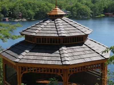 Wooden gazebo overlooking a lake, with a multi-tiered roof.