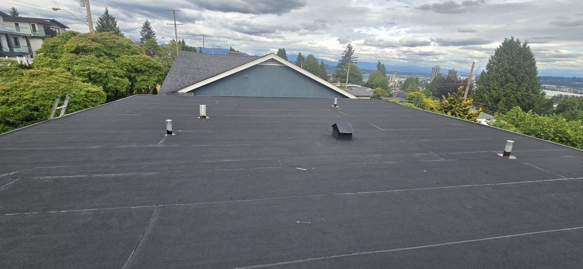 Flat roof replacement with torch on SBS membrane at Massey St and 8th Ave New Westminster BC by Paragon Roofing BC