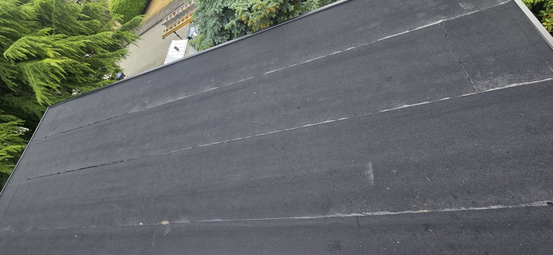 New metal edge flashing on flat roof perimeter at Massey St New Westminster, Paragon Roofing BC