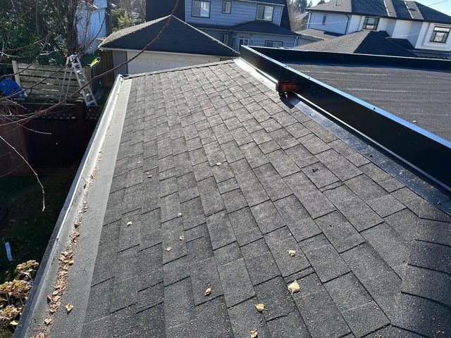 Shingled roof transitioning to a flat membrane roof section