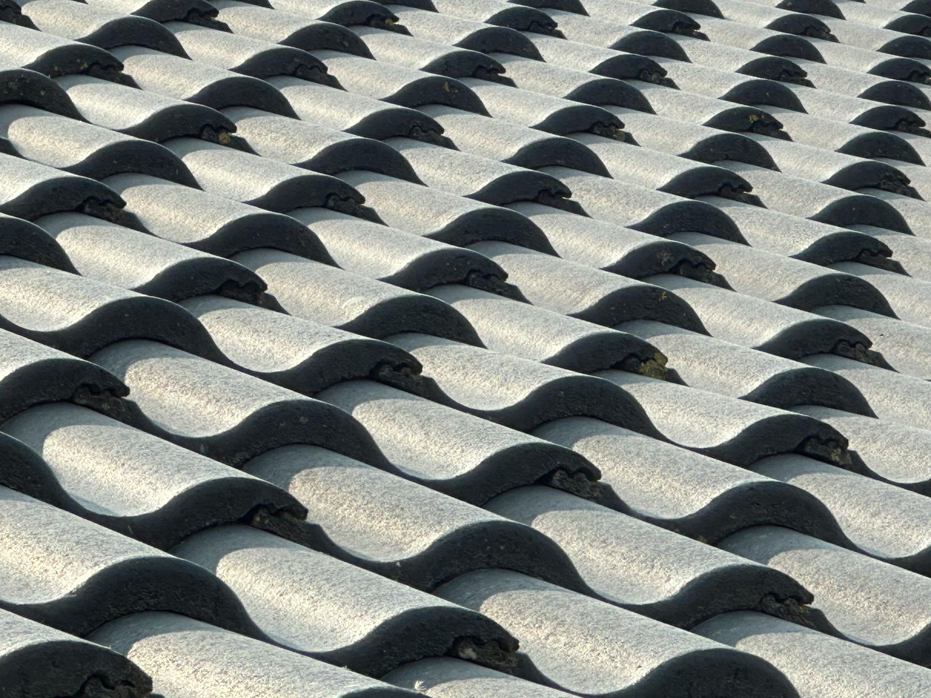 Solar panels against a blue sky with white puffy clouds.