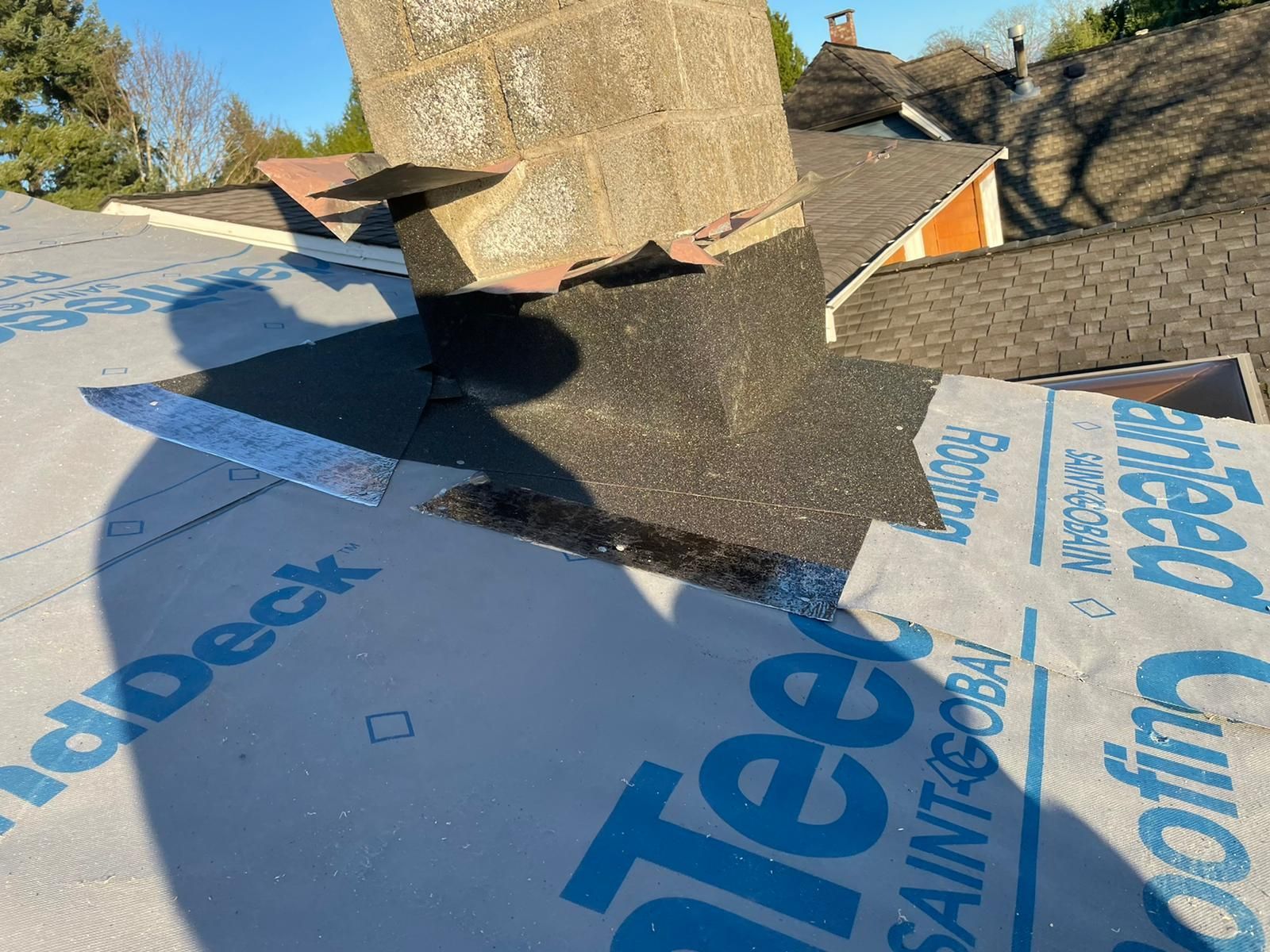 A chimney is sitting on top of a roof with a piece of paper on it.