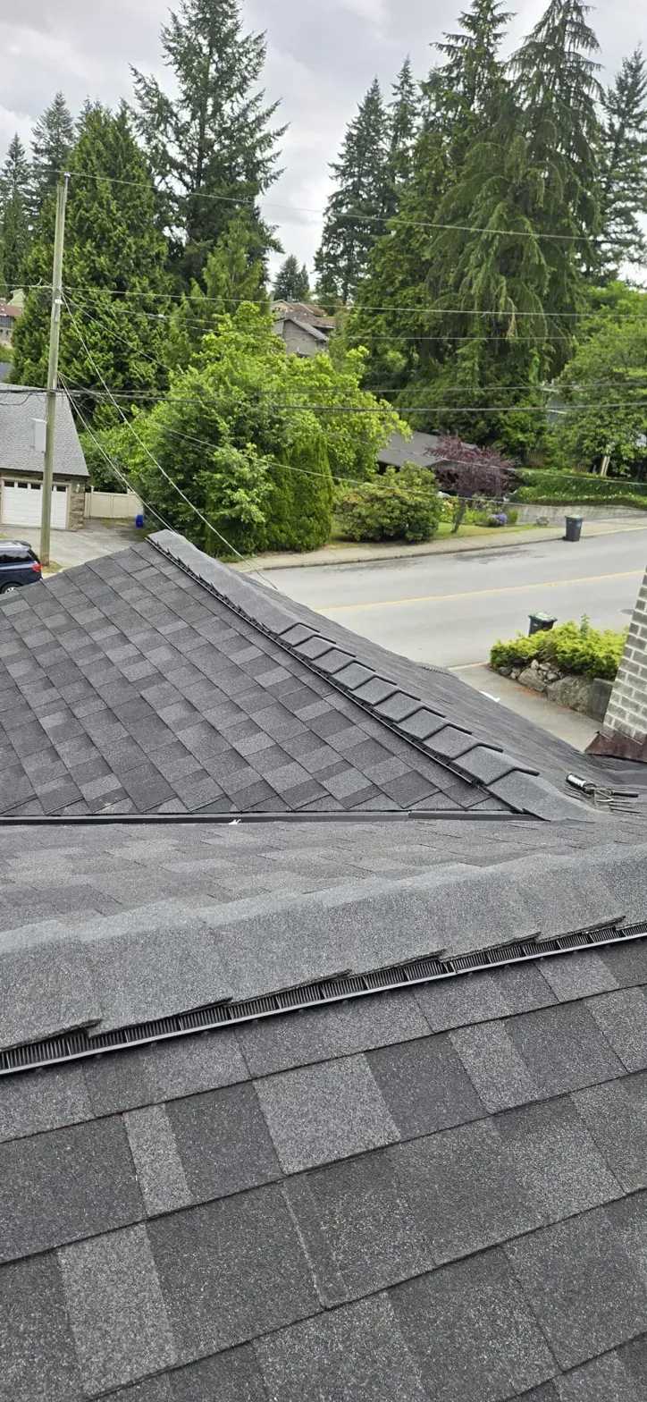 Completed cedar shake to IKO Dynasty conversion with vented ridges on Thermal Drive Coquitlam, hip and gable roof, Paragon Roofing BC