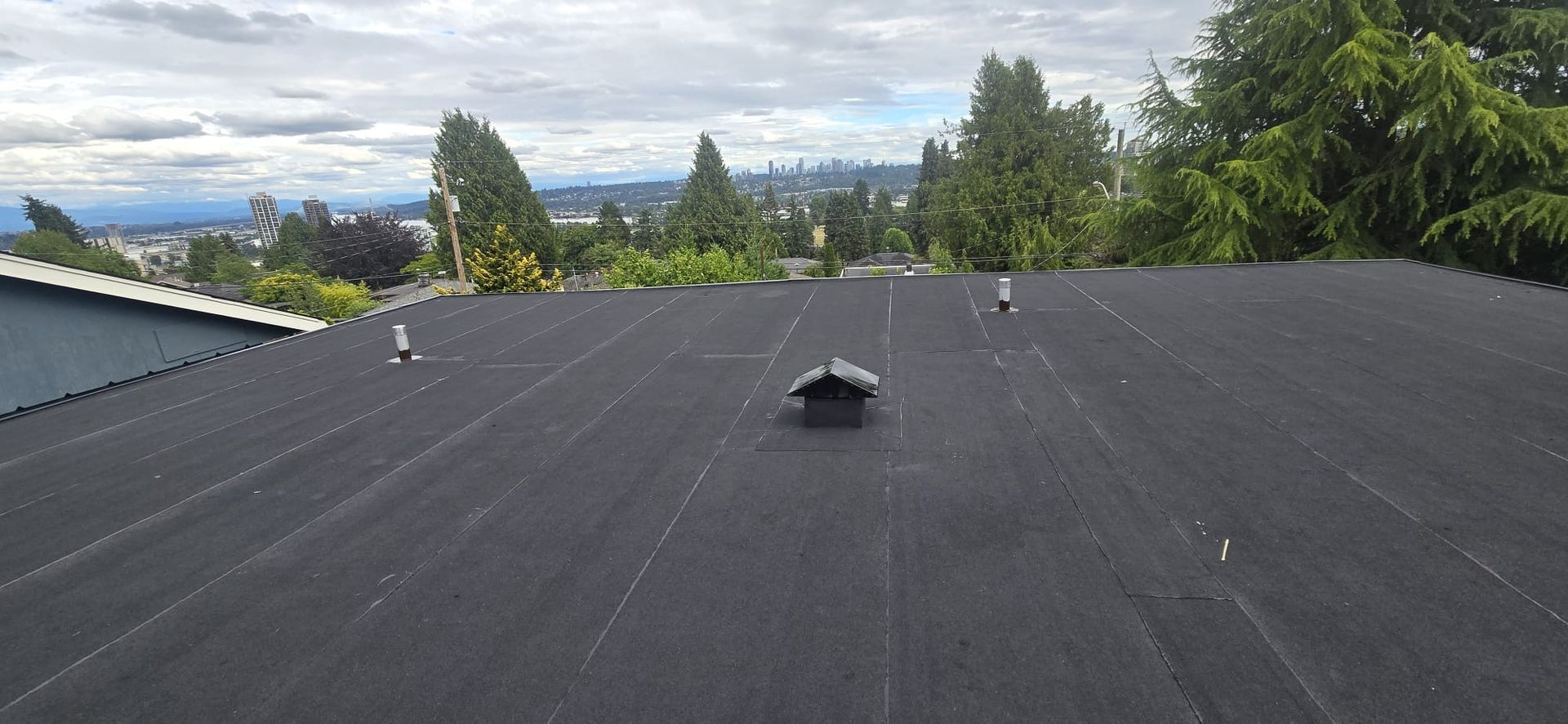 Torch on SBS membrane flat roof overlooking New Westminster and the Fraser River, heat welded seams, Paragon Roofing BC
