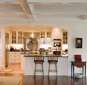 Bright kitchen with white cabinets, black countertops, and two stools at a breakfast bar in Rockville