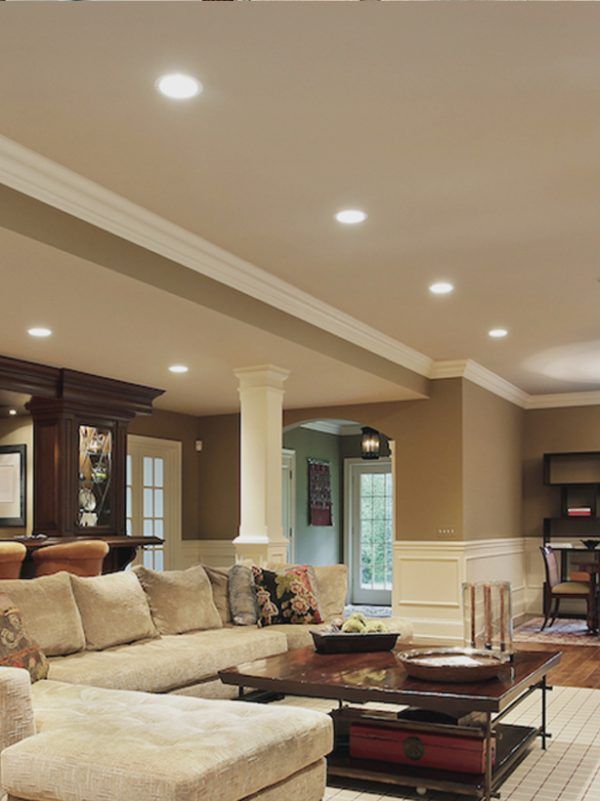 Spacious beige living room with sectional sofa, coffee table, columns, and recessed ceiling lights in Gaithersburg