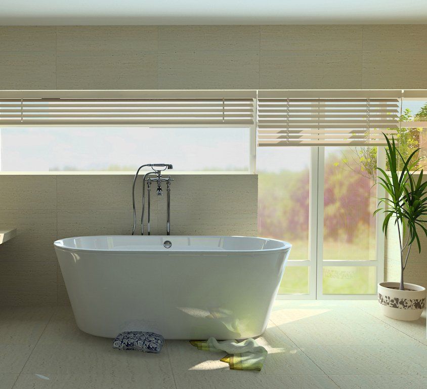 Modern bathroom with a freestanding white tub, large windows, and sunlight streaming across the floor in Kentlands