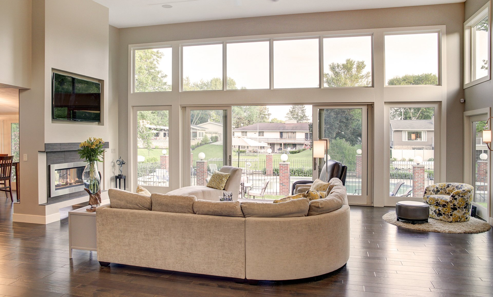 A living room with a large sectional couch and a yellow coffee table